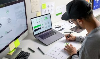 Asian,Graphic,Designer,Making,Notes,On,Logo,Designs,,Using,Computers,