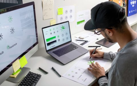 Asian,Graphic,Designer,Making,Notes,On,Logo,Designs,,Using,Computers,